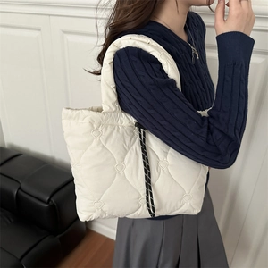 Quilted beige puffer tote bag with heart embroidery and drawstring details