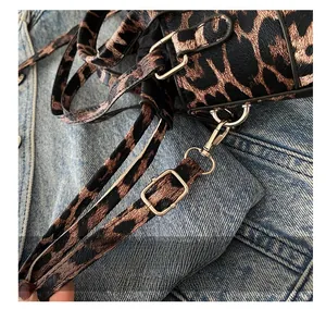 Close-up of adjustable metal buckle on stylish leopard print shoulder bag strap