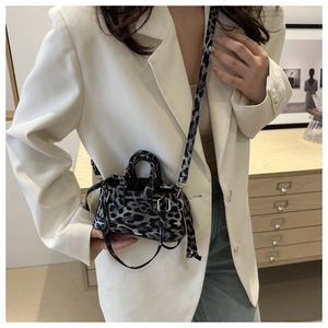 Chic leopard print mini tote bag styled with a white blazer and denim jeans for casual looks