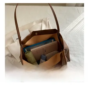 Top-down view of a brown tote bag showcasing spacious interior with daily essentials inside