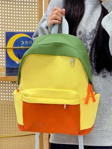 Close-up of color-block backpack showing green yellow and orange durable fabric textures