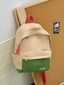 Detail of color-blocked canvas backpack with TKSS logo and durable zipper straps