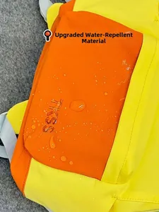 Detail of color-block backpack showing waterproof fabric and textured weave finish
