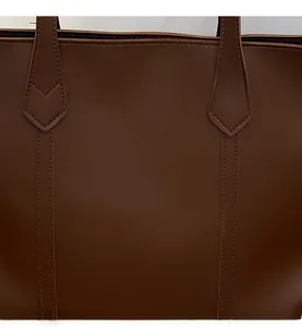 Detailed close-up showing the high-quality stitching and reinforced handle of the brown tote bag