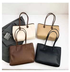 Minimalist tote bags in four neutral colors with long straps and vertical stitching details