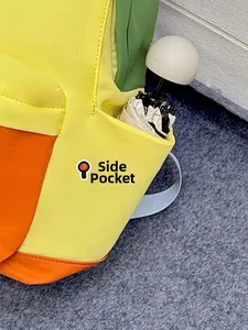 Close-up of functional side pocket on color-block backpack holding a white umbrella
