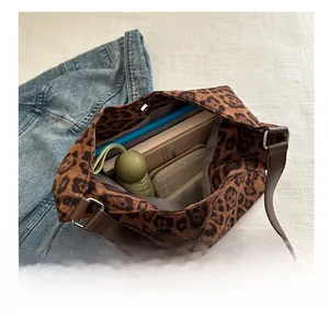 Spacious leopard print tote bag interior showing capacity with a notebook and umbrella