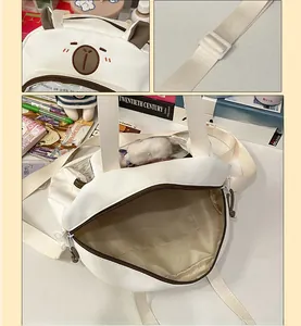 Detail of cute bear ears and adjustable nylon shoulder strap on the white school bag
