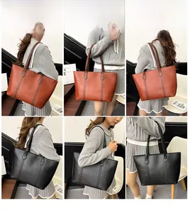 Detailed close-up showing the brown and black tote bags with textured synthetic leather
