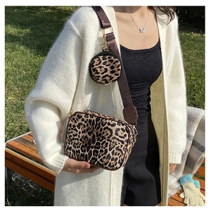 Close-up of leopard print crossbody bag with round coin purse and gold hardware