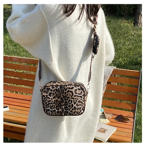 Detail of leopard print crossbody bag with detachable mini round coin purse and gold hardware