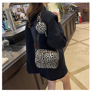 Detail of leopard print crossbody bag set with detachable round coin purse and wide strap