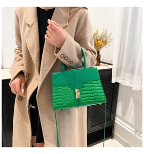 Green leather crossbody bag with crocodile pattern and golden rotating metal lock buckle