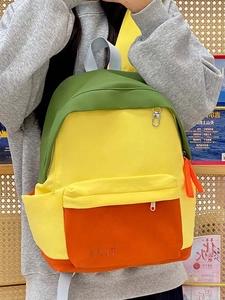 Detail view of the side profile on a vibrant color-block backpack for students