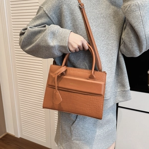 Structured caramel brown crocodile embossed handbag with top handles and shoulder strap