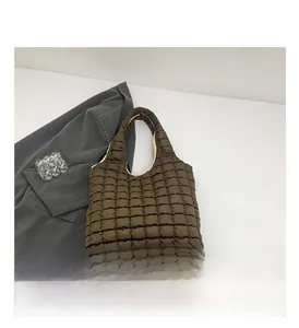 Detail view of brown quilted cloud bag featuring soft nylon material and puffer pattern