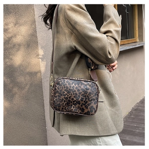 Detail of leopard print crossbody bag with detachable wide strap and small round coin purse