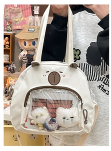 Close-up of white canvas tote featuring cute bear embroidery and transparent display window