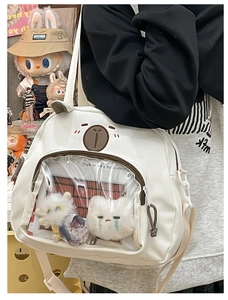 Close-up of cute white ita bag with bear embroidery and clear display window for plushies
