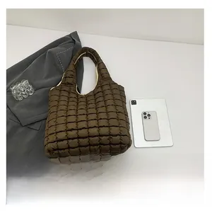 Brown puffer tote bag size comparison with tablet and phone on white background