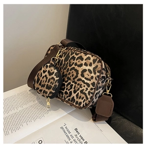 Detailed shot of leopard print camera bag set with round coin purse and gold hardware