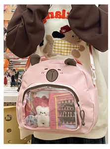 Pink bear-shaped ita bag featuring clear display window with plush doll and cute ear detail