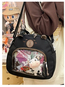 Detail of black bear shaped ita-bag with clear PVC window and cute cartoon ear design