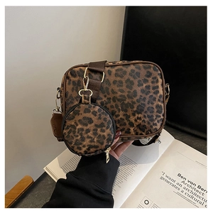 Detail of leopard print crossbody bag with matching round coin purse and brown strap