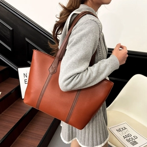 Large brown minimalist faux leather tote bag for women showing spacious commuter design