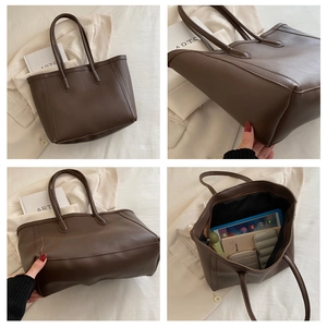 Detail view of deep brown tote bag with large capacity, stitching, and interior space