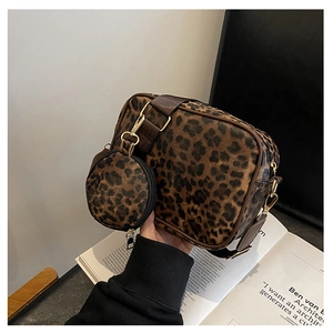 Detail view of leopard print crossbody bag with mini round pouch and gold hardware