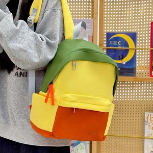 Contrast color school backpack in yellow green and orange with TKSS logo design