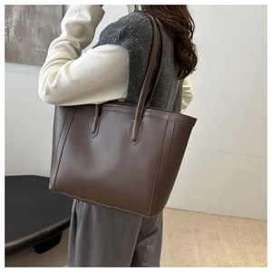 Deep coffee large tote bag detail showing smooth leather texture and sturdy shoulder straps