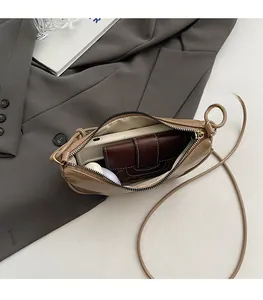 Detail showing the spacious interior of this khaki PU leather crossbody bag for women
