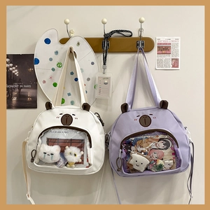 Close-up of cute cartoon bear bags with transparent PVC windows for doll display
