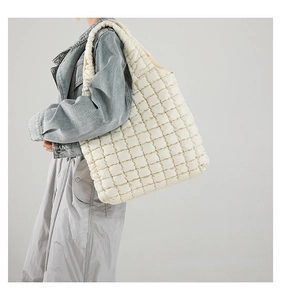 Detailed view of the creamy white quilted puff shoulder bag in a large tote style