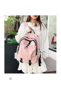 Pink waterproof nylon backpack with drawstring pocket and side water bottle holder