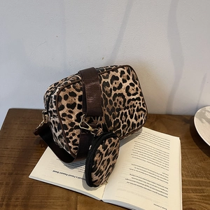 Chic leopard print crossbody bag set with wide nylon strap and round coin purse on a wooden table