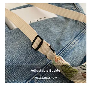 Close-up of adjustable buckle on ethnic leaf print canvas tote with woven strap