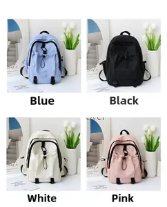 Detail view of nylon backpacks in blue, black, white, and pink with adjustable buckles