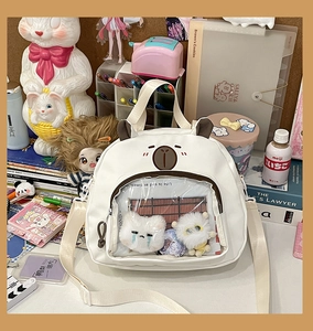 Close-up of cute white bear cartoon bag with transparent PVC window and plush toy