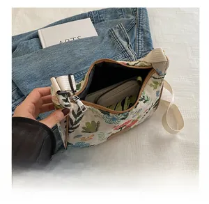 Detail view of the spacious interior of a floral jacquard canvas bag for daily items