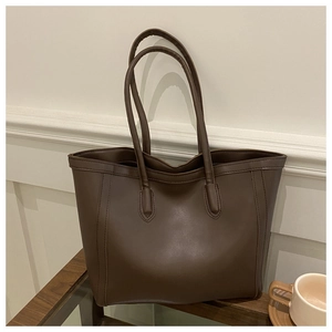 Detail view of deep brown large tote bag showing high-quality PU leather and fine stitching