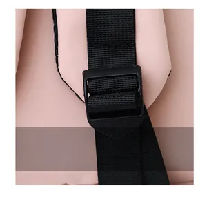 Detail of adjustable black nylon strap with plastic buckle on a pink student backpack