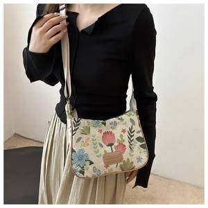Detailed view of floral jacquard pattern canvas bag with adjustable wide fabric strap