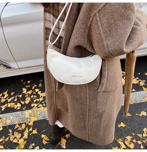 White half-moon crossbody bag in smooth PU leather with golden text print
