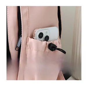 Close-up of pink nylon backpack side pocket with drawstring and smartphone insert