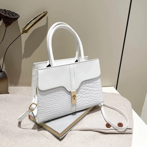 Elegant white crocodile embossed leather handbag with gold clasp and top handle