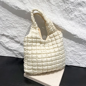 Chic beige quilted puff tote bag with cloud texture and spacious minimalist design
