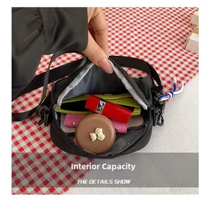 Detail view of the nylon crossbody bag interior with gray lining and zip closure